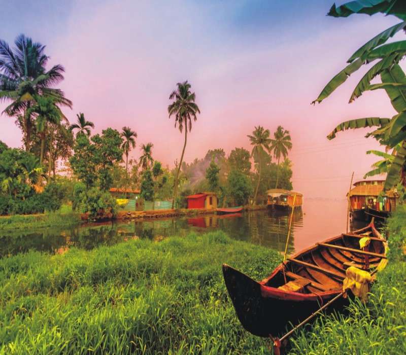 "Boats sailing through the scenic backwaters of Alappuzha, showcasing the charm of Kerala's waterways and traditional boat rides."