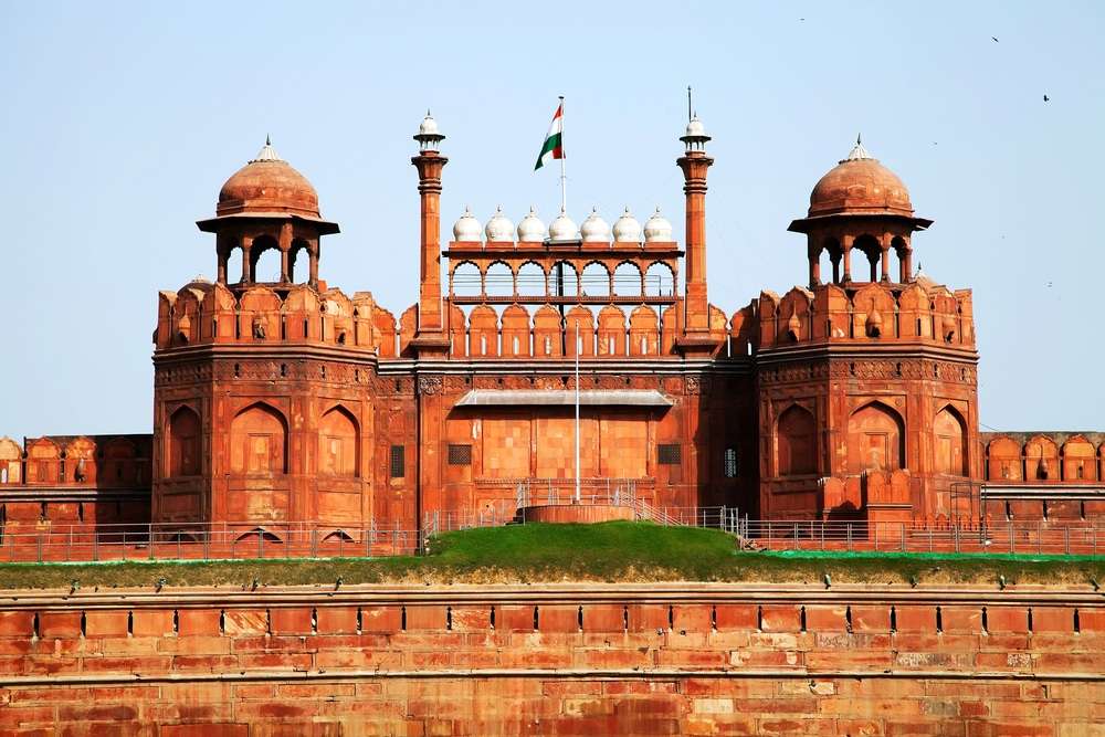 A stunning image of the majestic Red Fort in Delhi, showcasing its red sandstone walls and intricate Mughal architecture, representing India's rich history and cultural heritage."