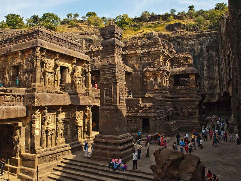 "The entrance of Ajanta and Ellora Caves in Aurangabad, Maharashtra, India, with intricate carvings and sculptures on the walls."