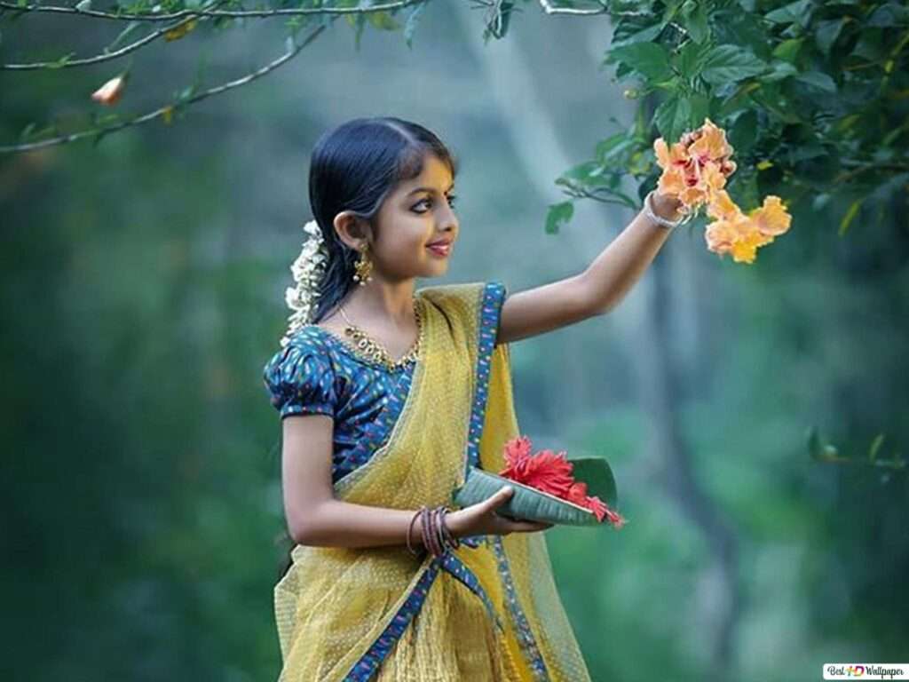 Cute little girl hooking off the flower from the tree of Kerala forest.