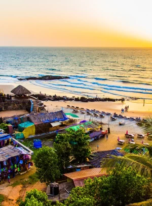 Aerial view of beaches in Goa, with people and umbrellas visible.