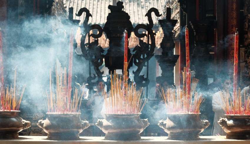 "Incense sticks burning at the Vĩnh Tràng Temple Buddhist temple in Vietnam"