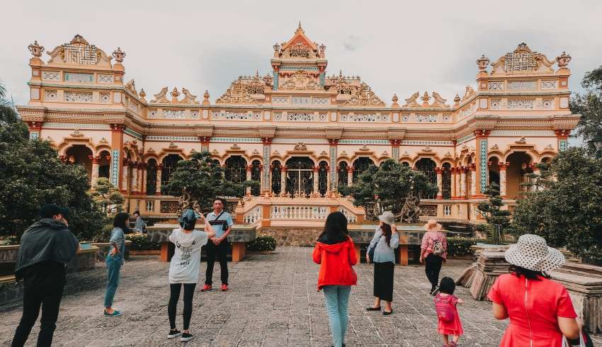 "Vĩnh Tràng Temple Buddhist temple with colorful pagodas, statues, and gardens in Vietnam"