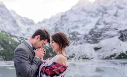 Honeymoon in Switzerland and Netherland in Winter wedding couple embracing by the frozen lake in the mountains.